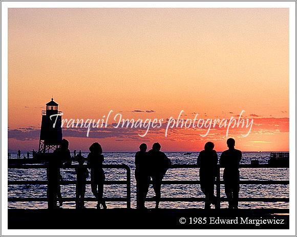 350124---People taking in a beautiful sunset over Lake Michigan in Charlevoix 